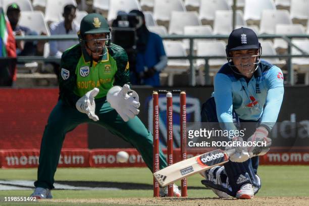England's Tom Banton is watched by South Africa's Quinton de Kock as he plays a reverse sweep shot during the first one day international cricket...