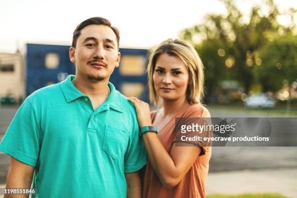 beautiful millennial couple posing for portrait - serious couple stock pictures, royalty-free photos & images