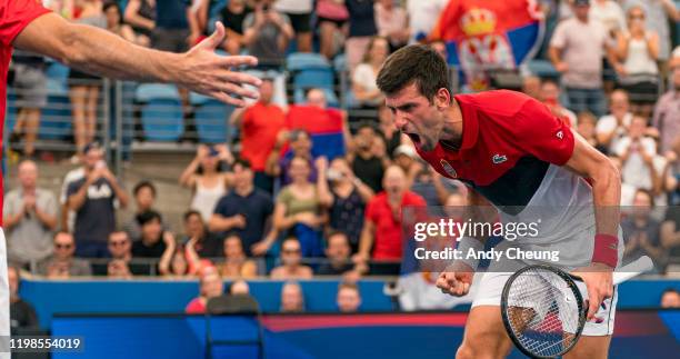 Novak Djokovic of Serbia celebrates winning match point during his quarter final singles match against Denis Shapovalov of Canada during day eight of...