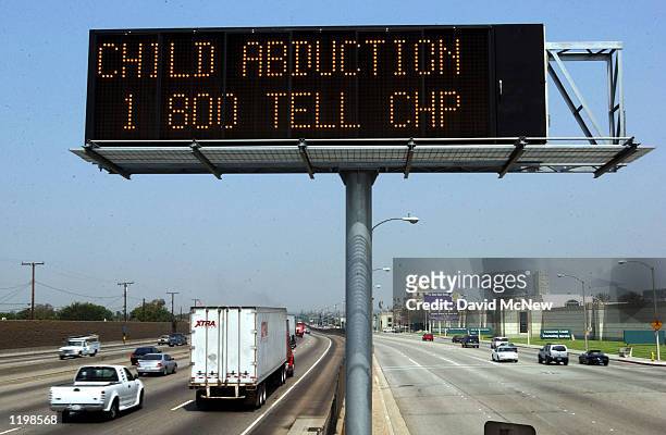 Caltrans freeway sign over Interstate 5 flashes "child abduction 1 800 TELL CHP" in addition to the description of a suspect's vehicle as part part...