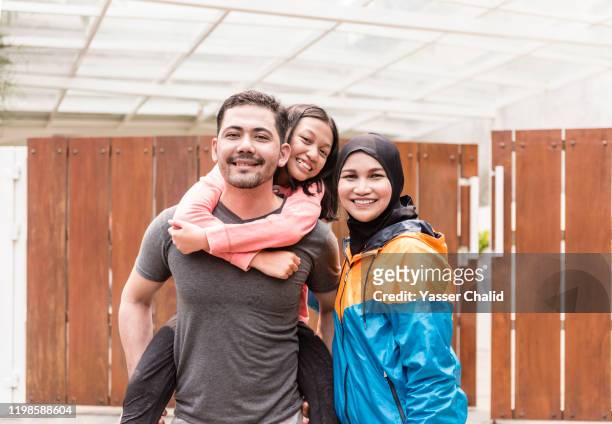 indonesian family sporty portrait - indonesia family stock pictures, royalty-free photos & images
