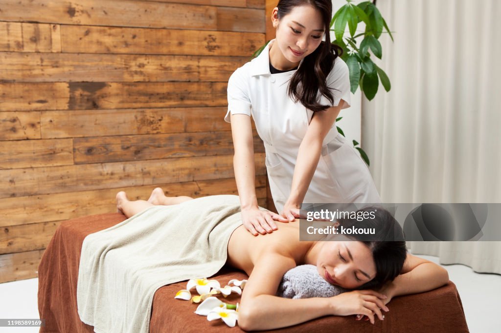 Mujer recibiendo masaje con aceite de aroma