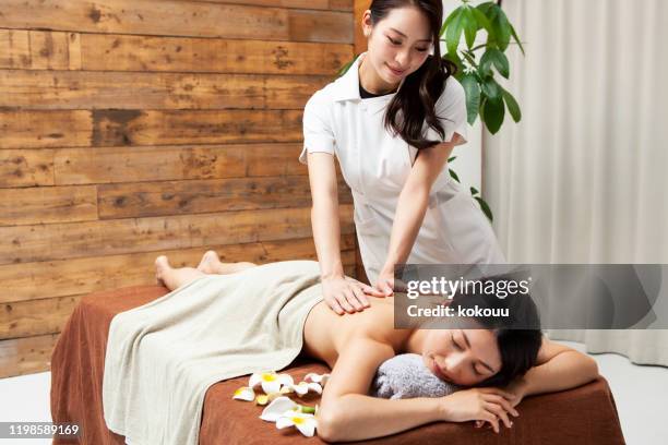 woman receiving massage using aroma oil - day spa stock pictures, royalty-free photos & images