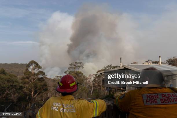 Fire fighters watch on as fire approaches a property on January 10, 2020 in Penrose, Australia. NSW is bracing for severe fire conditions, with high...