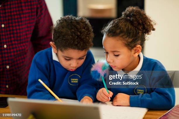 working on their writing - kid writing stock pictures, royalty-free photos & images