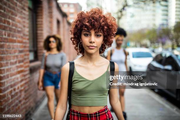 in a walk with her best friends - young woman red hair urban stock pictures, royalty-free photos & images