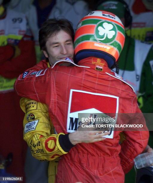 Eddie Irvine of Northern Ireland hugs second placed Heinz-Harald Frentzen of Germany after winning the 1999 Australian Formula One Grand Prix in...