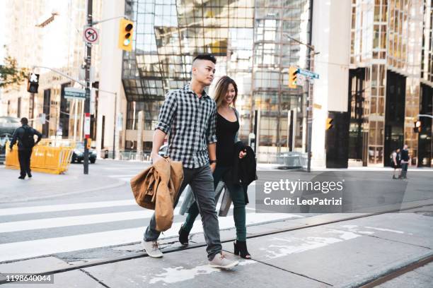 asian couple in toronto city street - toronto people stock pictures, royalty-free photos & images