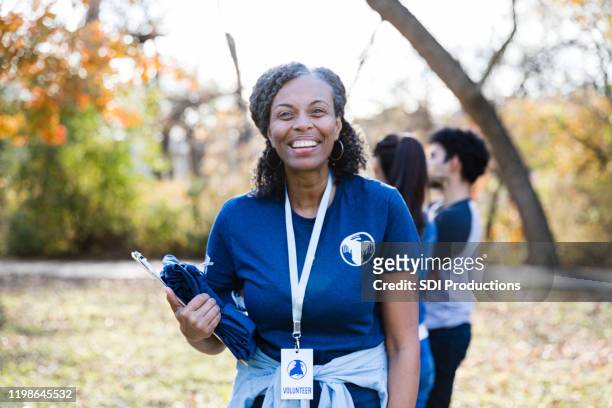 confident female volunteer - woman volunteer stock pictures, royalty-free photos & images