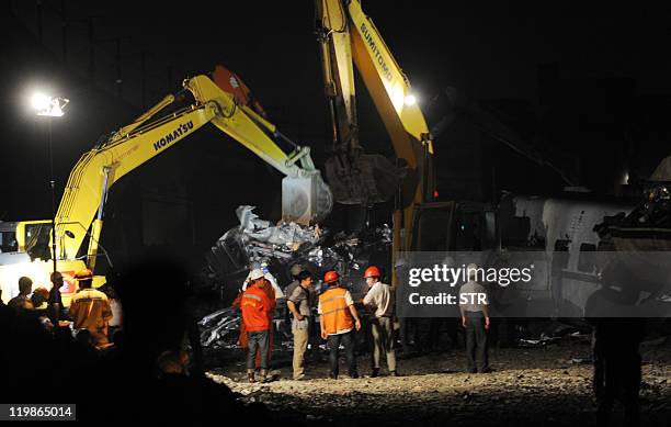 Heavy machinery sorts through debris from a fatal high-speed train collision in Shuangyu, on the outskirts of Wenzhou in the eastern Chinese province...