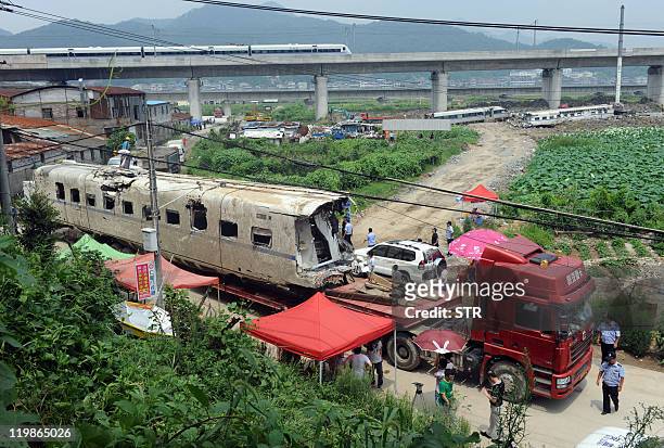 The wreckage of high-speed train carriage is carried on a truck, two days after a fatal collision, in Shuangyu, on the outskirts of Wenzhou in the...