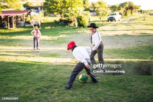 young gaucho footballers playing outdoors - gaucho ball stock pictures, royalty-free photos & images