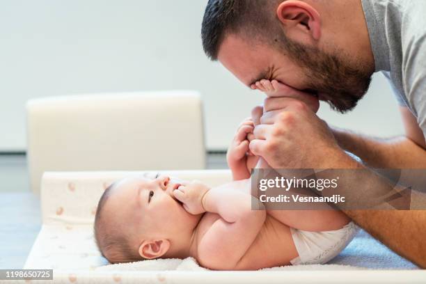 morning cuddling - changing diaper stock pictures, royalty-free photos & images