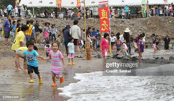 People enjoy the Funado beach opening ceremony on July 24, 2011 in Kuji, Iwate, Japan.