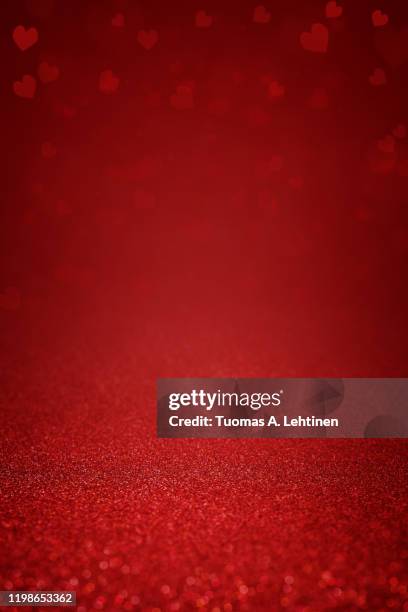 glittering red abstract background with hearts - valentines background stock-fotos und bilder