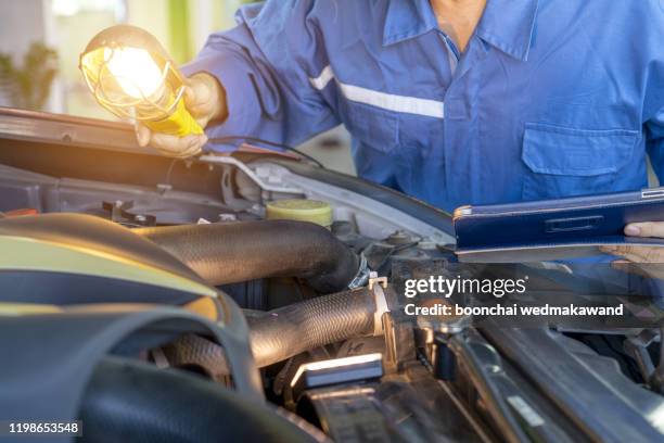 auto mechanic working in garage. repair service. - auto tuning stock pictures, royalty-free photos & images