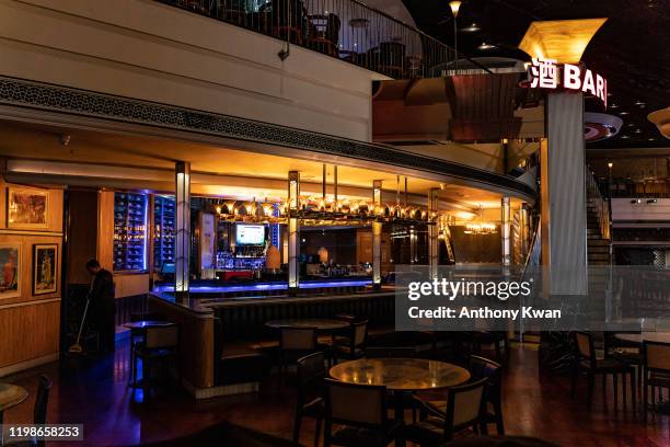 An employee cleans an empty bar at The Venetian Macau after the closing of its casino on February 5, 2020 in Macau, China. Macau government announced...