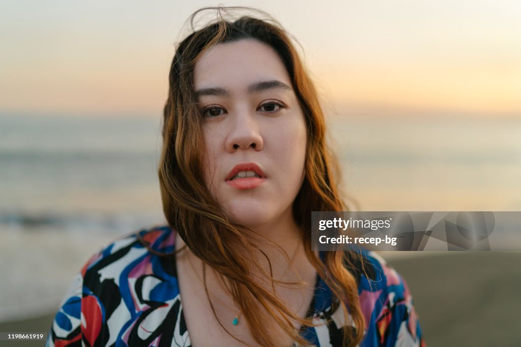 Portrait of beautiful woman by the sea