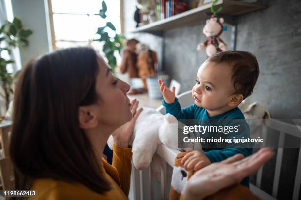 mother and baby boy trying to understand each other - six month old stock pictures, royalty-free photos & images