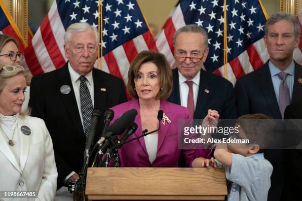 House Speaker Nancy Pelosi speaks as House Majority Leader Steny Hoyer and Senate Minority Leader Chuck Schumer look on at during a news conference...