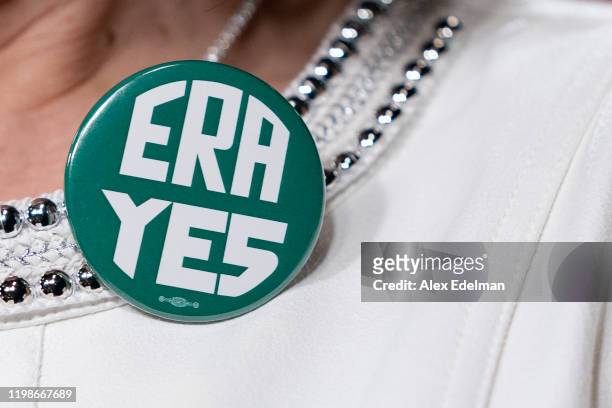 Rep. Jackie Speier wears a button supporting passage of the Equal Rights Amendment as she waits to speak during a news conference with members of the...
