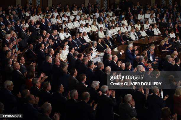 Members from the House of Representatives with most Democratic ladies wearing white, listen to US president Donald Trump deliver the State of the...