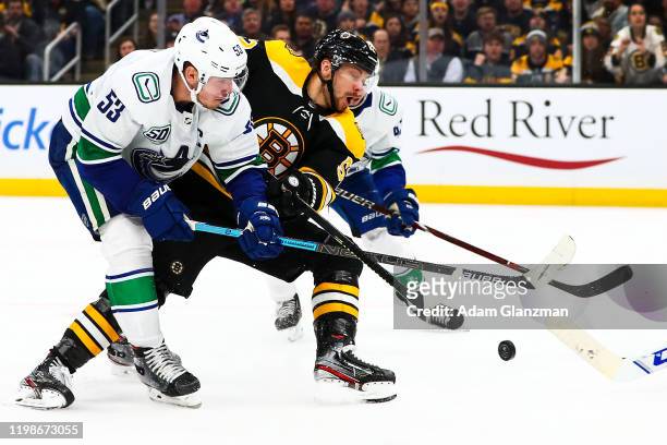 Sean Kuraly of the Boston Bruins battles for the puck during a game against the Vancouver Canucks at TD Garden on February 4, 2020 in Boston,...