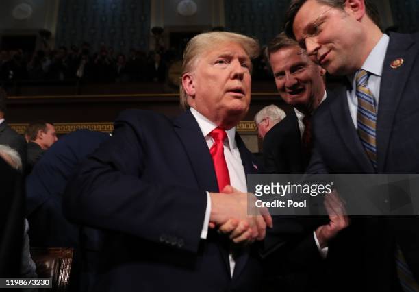 President Donald Trump is greeted by Rep. Mike Johnson before the State of the Union address in the House chamber on February 4, 2020 in Washington,...