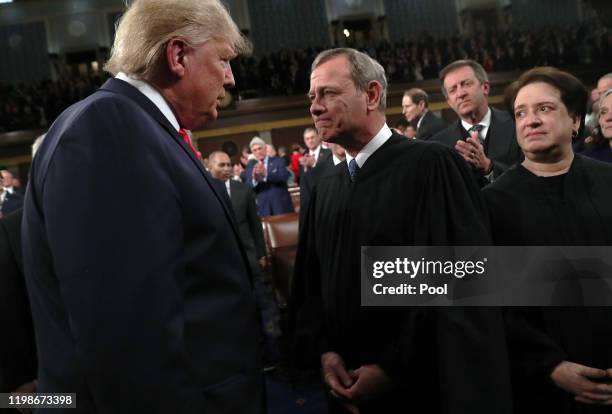 President Donald Trump talks with Supreme Court Chief Justice John Roberts as Associate Justice Elena Kagan looks on before the State of the Union...