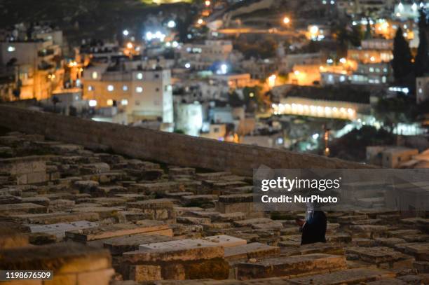 Man seen praying at Jerusalem's Jewish Cemetery. On Tuesday, February 4 in Jerusalem, Israel.