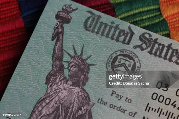 partial view on a us treasury payment check - government check stock pictures, royalty-free photos & images