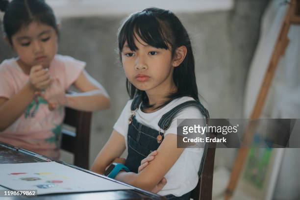 leave me alone; thai baby girls having problems while studying in art class - students arguing stock pictures, royalty-free photos & images