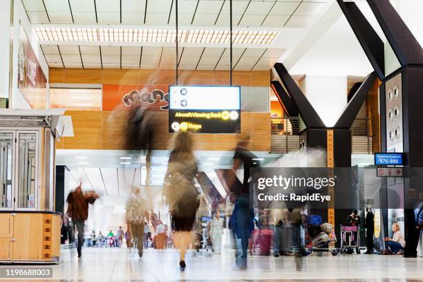 passengers walking through concourse at johannesburg airport - tambo international airport stock pictures, royalty-free photos & images