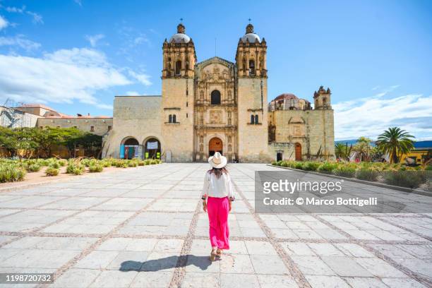 one woman walking towards the oaxaca monastery, mexico - oaxaca stock pictures, royalty-free photos & images