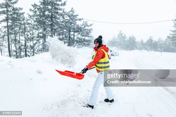 snowy road shoveling - shoveling driveway stock pictures, royalty-free photos & images