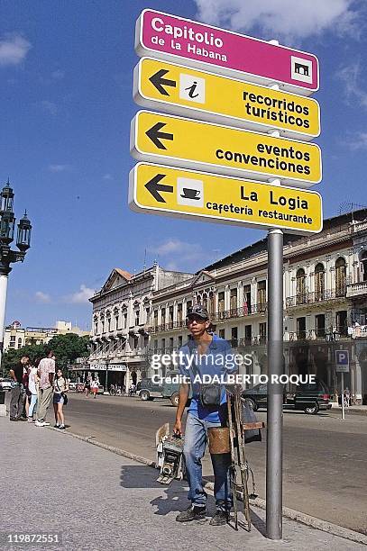 Street photographer in Havana looks for tourists 30 December, 1999. Cuban tourism authorities reported that some 50,000 tourists have cancelled their...