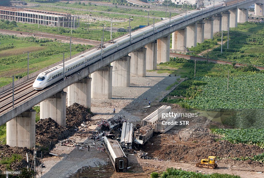 A bullet train passes the wreckage of tw