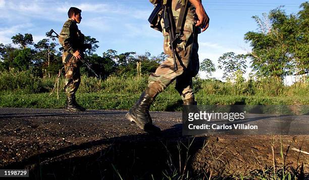 Colombian soldiers patrol the highway that leads to San Vicente del Caguan from their base in Caqueta, Colombia on July 31, 2002. Despite a strong...