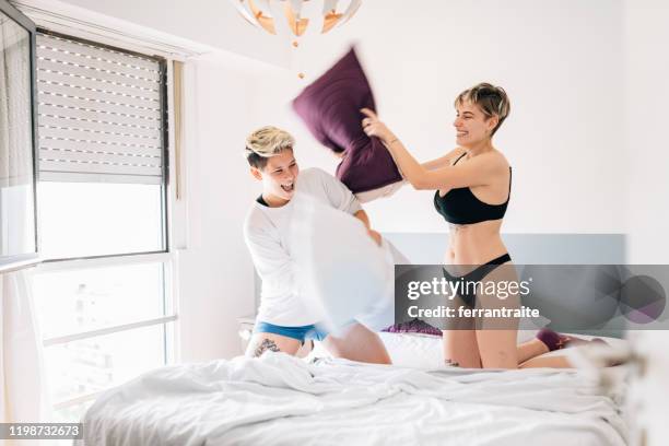 lesbian couple pillow fight - kids in undies stock pictures, royalty-free photos & images