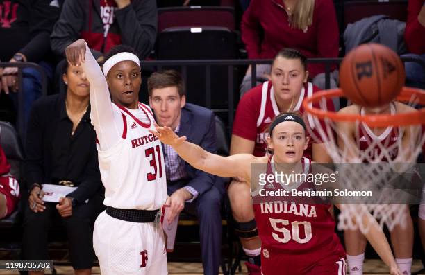 Tekia Mack of the Rutgers Scarlet Knights watches her three point attempt while being guarded by Brenna Wise of the Indiana Hoosiers at Rutgers...