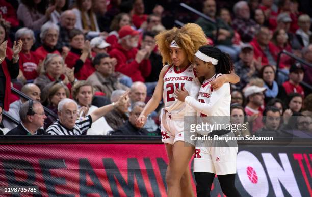 Arella Guirantes of the Rutgers Scarlet Knights is helped off the court by Zipporah Broughton during a game against the Indiana Hoosiers at Rutgers...