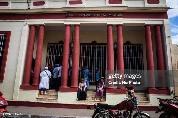 People await outside the Banco de Crédito y Comercio in Trinidad, Cuba, on January 21, 2020. Trinidad is a town in the province of Sancti Spíritus,...