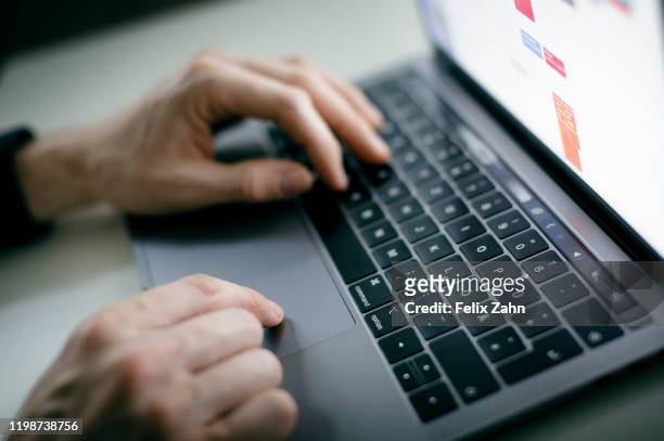 Symbol photo. A man is typing with his hands on a keyboard of a MacBook Pro on February 04, 2020 in Berlin, Germany.