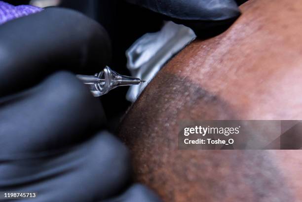 micro-pigmentation de cuir chevelu de l'homme afro-américain chauve - maquillage permanent photos et images de collection
