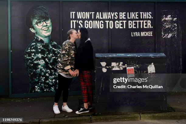 Robyn Peoples and Sharni Edwards, Northern Ireland's first same-sex couple to be legally married embrace and kiss in front of the Lyra McKee mural...