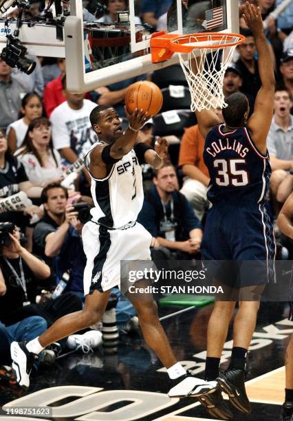 Stephen Jackson of the San Antonio Spurs does a reverse layup past Jason Collins of the New Jersey Nets during the first half of game two of the NBA...