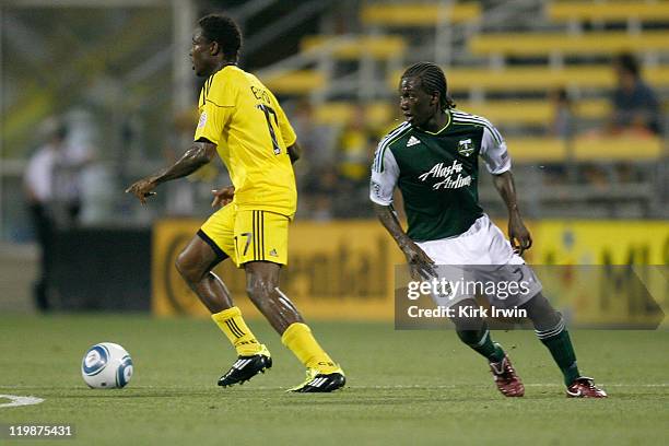 Emmanuel Ekpo of the Columbus Crew dribbles the ball past Diego Chara of the Portland Timbers on July 23, 2011 at Crew Stadium in Columbus, Ohio....