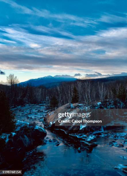 androscoggin river with white mountains in background during winter in berlin, new hampshire usa - white mountains new hampshire winter stock pictures, royalty-free photos & images