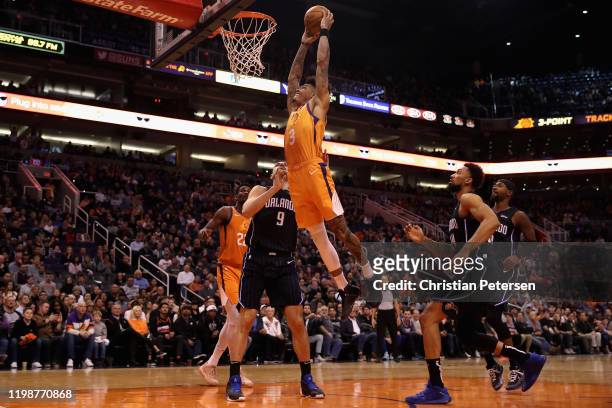 Kelly Oubre Jr. #3 of the Phoenix Suns slam dunks the ball over Nikola Vucevic of the Orlando Magic during the second half of the NBA game at Talking...