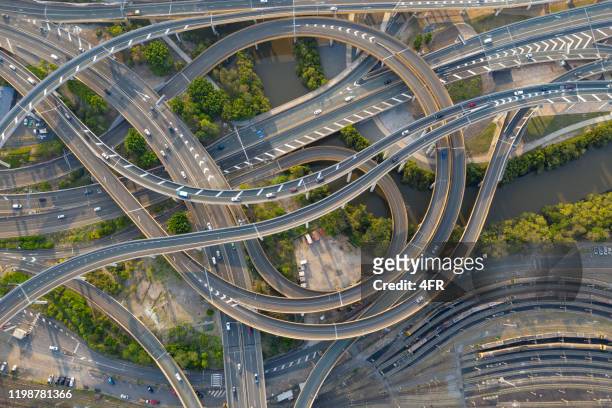 highway junction intersection and railroad tracks, brisbane, australia - road intersection stock pictures, royalty-free photos & images
